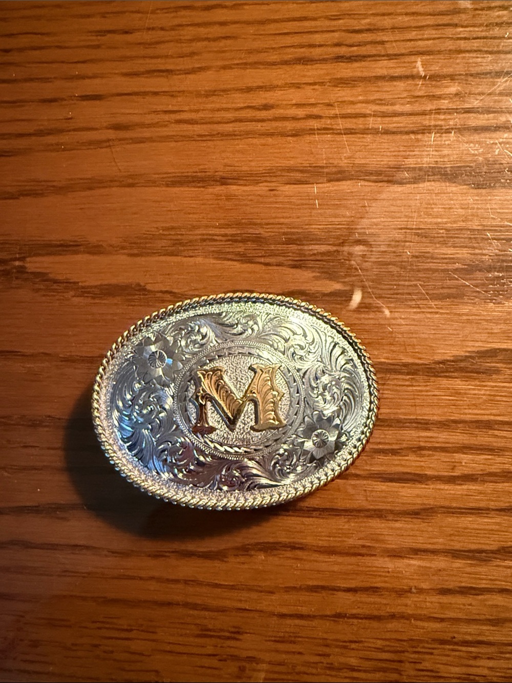 Montana Silversmith Monogram 'M' Engraved Silver-and gold belt buckle.